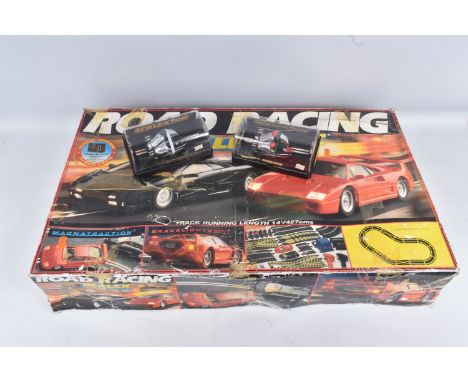 A BOXED SCALEXTRIC ROAD RACING SUPER SCALE SET, the set appears complete with two race cars, track, controller and trackside 