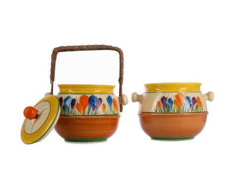 TWO BIZARRE BY CLARICE CLIFF CROCUS BISCUIT BARRELS,one with lid, one with rattan swing handle, this for Newport Pottery, the