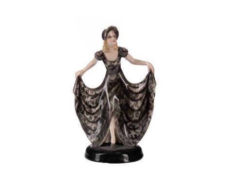 GOLDSCHEIDER FIGURE OF A LADY,modelled curtseying, on a circular base, impressed and printed marks to base, 19cm highConditio