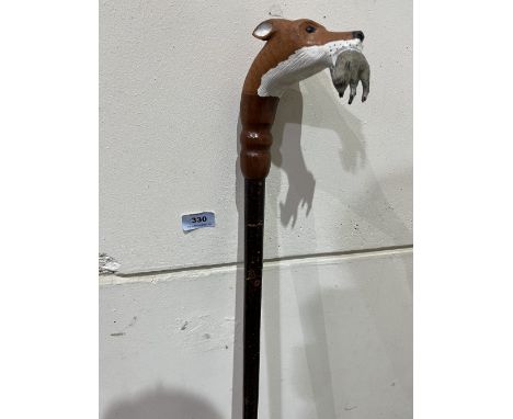 A hazel walking stick, the pommel hand carved as a fox with a rabbit in mouth. Glass eyes. 51½' long