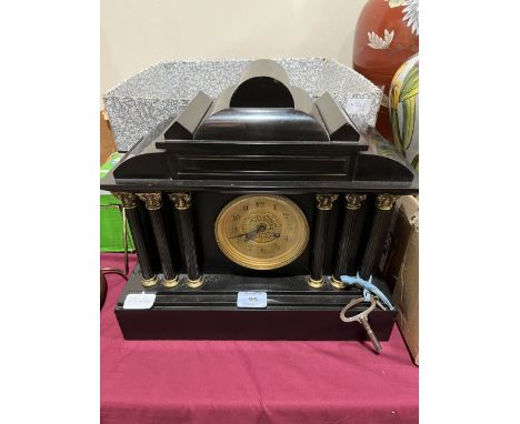 A late 19th century French mantle clock, the black slate architectural case with drum movement striking on a coiled gong. 14½