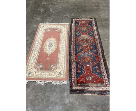 An eastern carpet runner 93' x 32' and a Chinese pink ground rug.