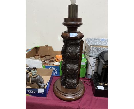 A carved mahogany and oak lamp base