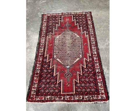 A red ground eastern carpet. 78' x 49'