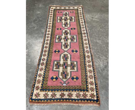 An eastern pink ground carpet runner. 108' x 42'