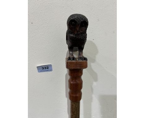 A hazel walking stick, the pommel hand carved as an owl with glass eyes. 53' long