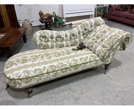 A Victorian chaise-longue with shaped button back and arm. Rear leg detached 
