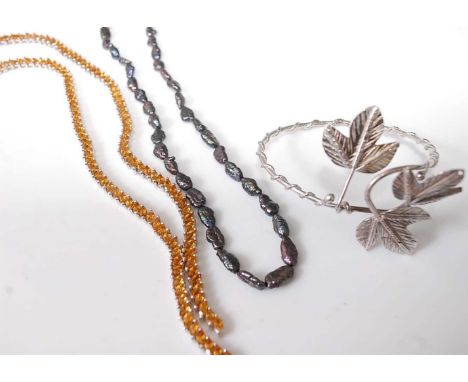 A contemporary natural black pearl necklace with 10ct gold clasp, together with a modern silver and paste set necklace and a 