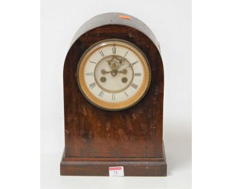A late 19th century MAHOGANY cased dome top mantel clock having an enamelled chapter ring with Roman numerals, and visible an