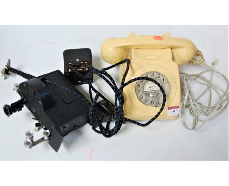 A Pathescope Ace 9.5mm cine-camera; together with various film and accessories, and a cream bakelite cased telephone 