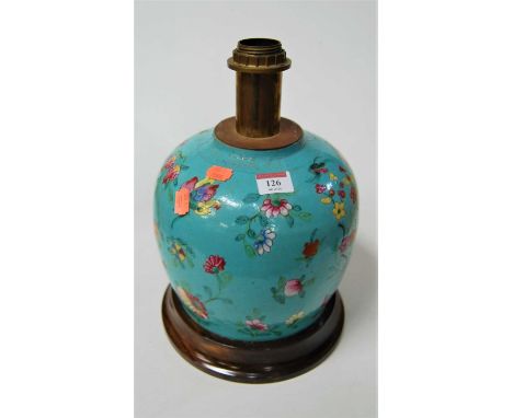 A Chinese stoneware ginger jar, of squat circular form, enamel decorated with flowers, on later mahogany plinth, h.26cm