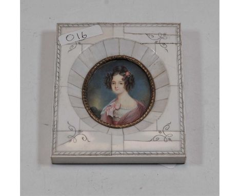 A reproduction portrait miniature depicting a lady in pink dress with pink rose in her hair within faux ivory surround, max d