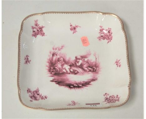 A late 19th century Sevres style porcelain dish, of shaped square form, the centre decorated in puce with two cherubs, within