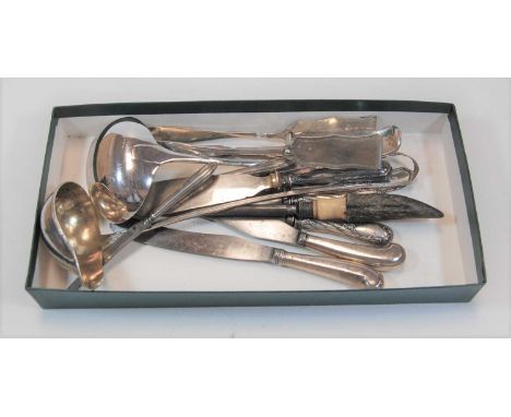 A collection of silver plated cutlery, to include a large soup ladle, fish slice, sugar nips, two pistol grip knives etc