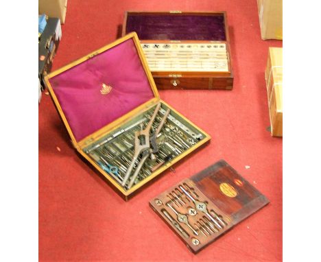 A 19th century mahogany and brass bound toolbox, the hinged lid revealing fitted interior with various  tap and dies, togethe