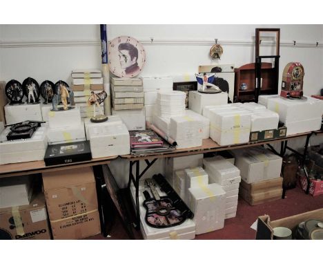 An extensive collection of Elvis Presley memorabilia, to include collectors plates, wall clock, framed prints, figurines, cer