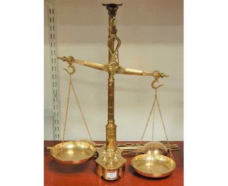 A set of large brass pan scales and weights together with a brass toasting fork, two brass spoons, etc