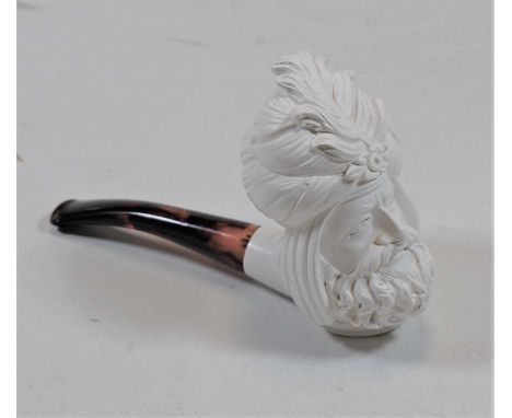 A modern Meerschaum type pipe, the bowl carved as a sultan's head, having a faux amber stem