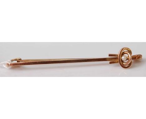 A yellow metal stick pin, set with a 2.2mm seed pearl, pin length 50mm, gross weight 2.3g, stamped and tested as 9ct