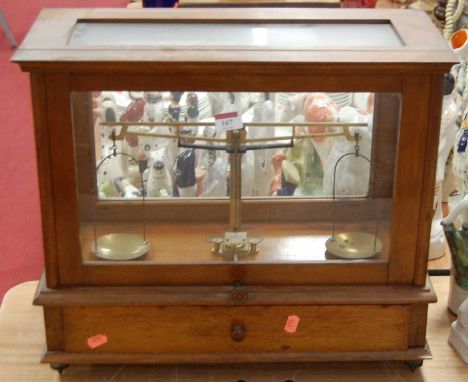 A set of chemist's laboratory scales in teak case bearing a label for Goodbrand &amp; Co. Ltd., makers Manchester &amp; Staly