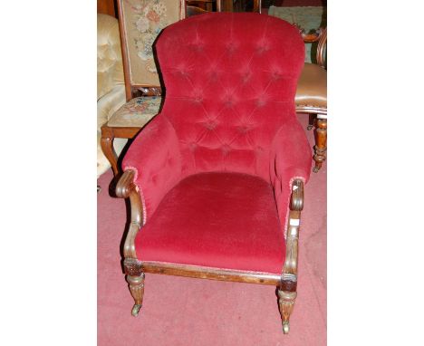 An early Victorian rosewood framed and red button backed upholstered spoonback armchair, having rolled arms and on turned and