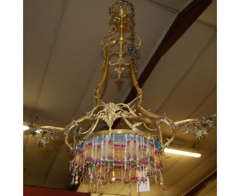 An early 20th century French brass five light hanging electrolier, having masked floral cast decoration, approx drop 90cm 