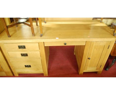A contemporary light oak kneehole desk, width 165cm