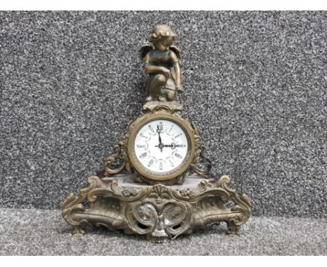 French ornate brass effect mantle clock with figured cherub decoration