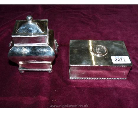 A plated Tea Caddy with lion head handles and ball feet, 5 1/2'' tall  and a plated cigarette Box with a George III coin embe