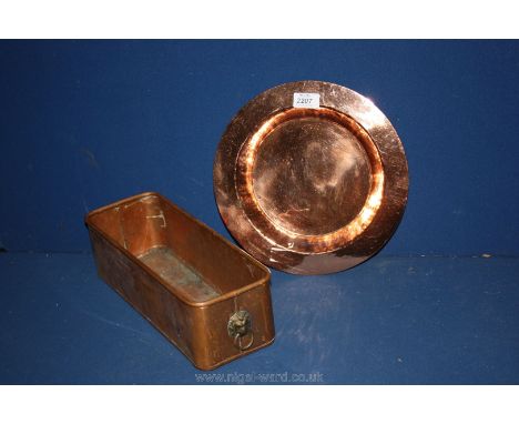 A copper flower trough with lion head handles, 14'' long and a copper plate 11 1/2'' diameter.