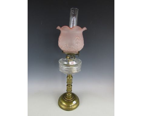A Victorian columnar oil lamp with petal pink glass shade