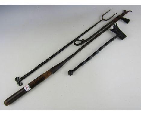 A wrought iron toasting fork and two wrought iron handle holders