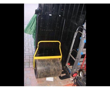 A set of sack trucks together with a garden roller