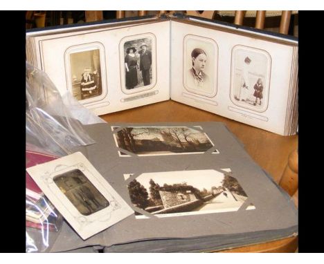 A vintage postcard album together with a Victorian family portrait album