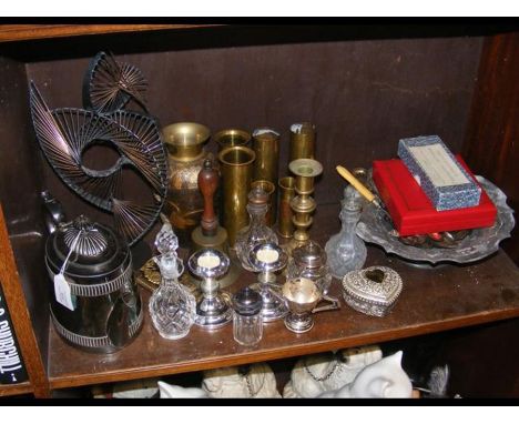 An assortment of metal ware including brass shell cases and silver plated tea pot