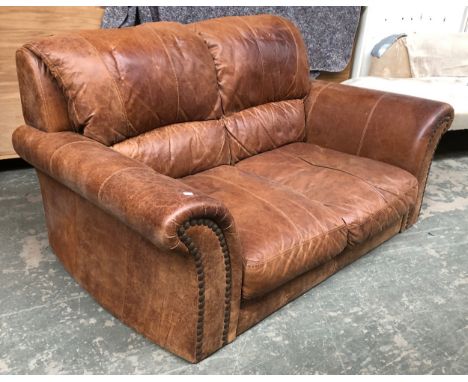 A two seater brown leather sofa, with turned legs, 161cmW approx. 98cmH 