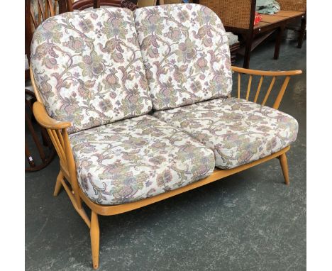 An Ercol beech stickback two seater sofa 