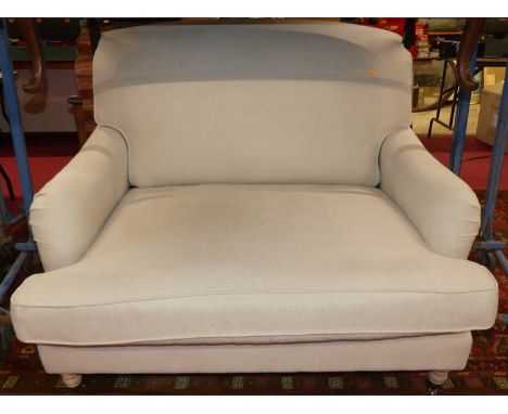 A contemporary Neptune oversized deep easy chair, pale fabric upholstered, raised on blond oak squat turned forelegs, width 1