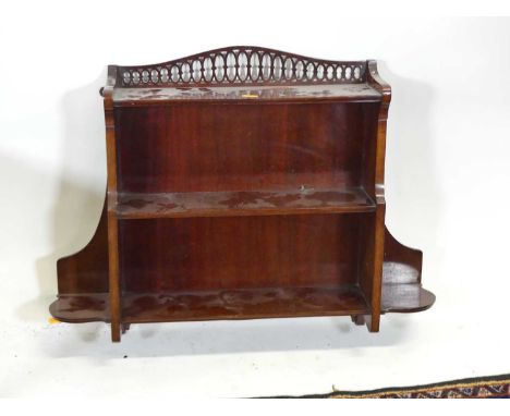 An Edwardian mahogany two-tier wall shelf, with fretwork upper decoration, width 66cm