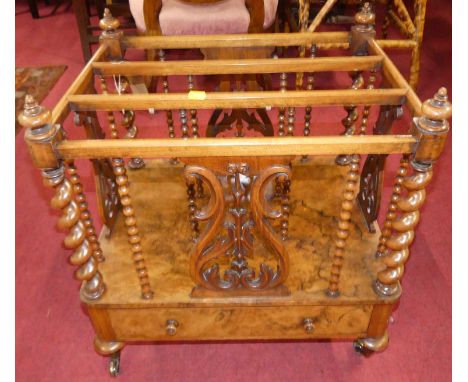 A mid-Victorian figured walnut three-division Canterbury, with spiral and bobbin turned columns, pierced floral fretwork pane