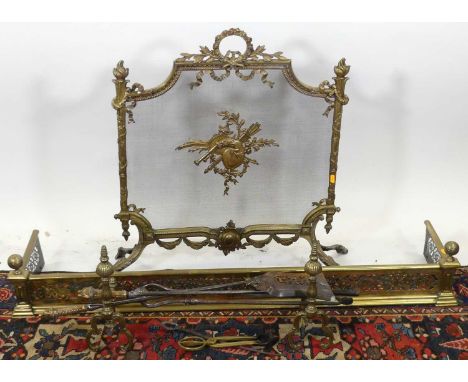 Sundry late 19th century brass fireside wares to include; pierced fender, pair of fire dogs, sundry fire tools, and a mesh in