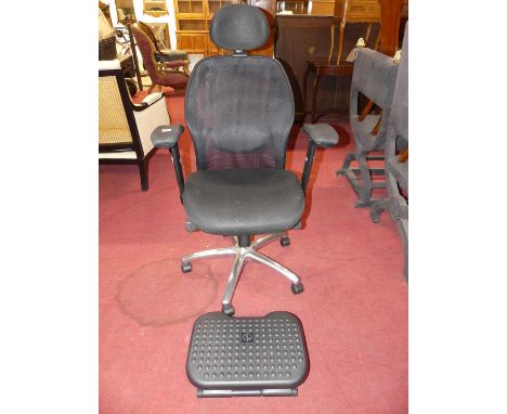 A contemporary swivel office desk chair, with rise and fall action, mesh uphostered, raised on aluminium five spoke base to r