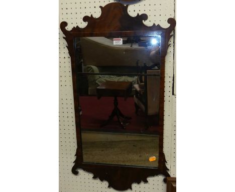 A collection of five similar mahogany and flame mahogany framed fret-cut rectangular wall mirrors, each in the Chippendale ta