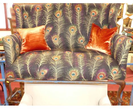 A 1920's walnut framed and recently reupholstered in Themis fabric by Sanderson two-seater wing back sofa, raised on cabriole