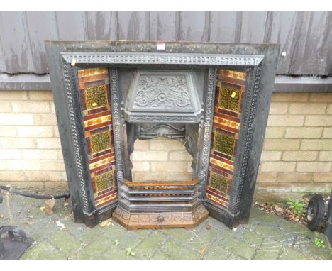 An Edwardian cast iron and tile inset fire surround, with integral grate and lower pull-out drawer, 97 x 96cmTiles are in ver