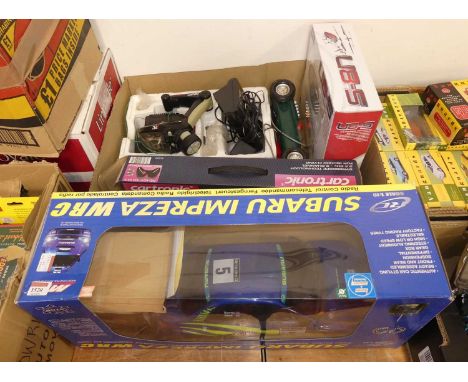 A collection of remote control cars and helicopters of various scales and manufactures, including two RC helicopters, in orig