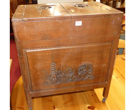 An Eastern camphorwood twin hinge top sewing table, raised on roller castors, width 56cm