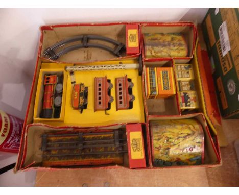 A collection of vintage tinplate 0 gauge trains, including a Mettoy boxed set, comprising of one loco, two coaches, track and