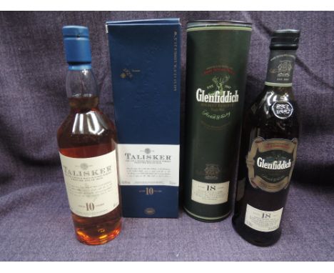 Two bottles of single scotch malt whisky. Talisker 10 year old and Glenfiddich Ancient Reserve 18 year old
