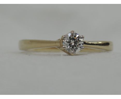 A lady's dress ring having a diamond solitaire, approx .25ct in a decorative claw mount on a 9ct gold loop,  size K